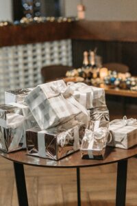 A collection of beautifully wrapped Christmas gifts with a festive indoor setting, perfect for holiday celebrations.